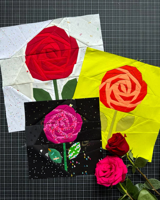 Quilt blocks with rose designs on a grid background